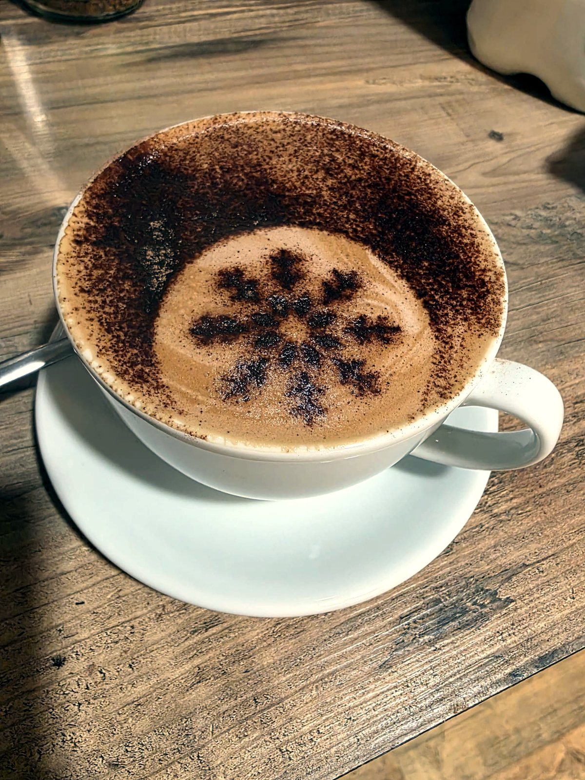 Cappuccino with cocoa snowflake art