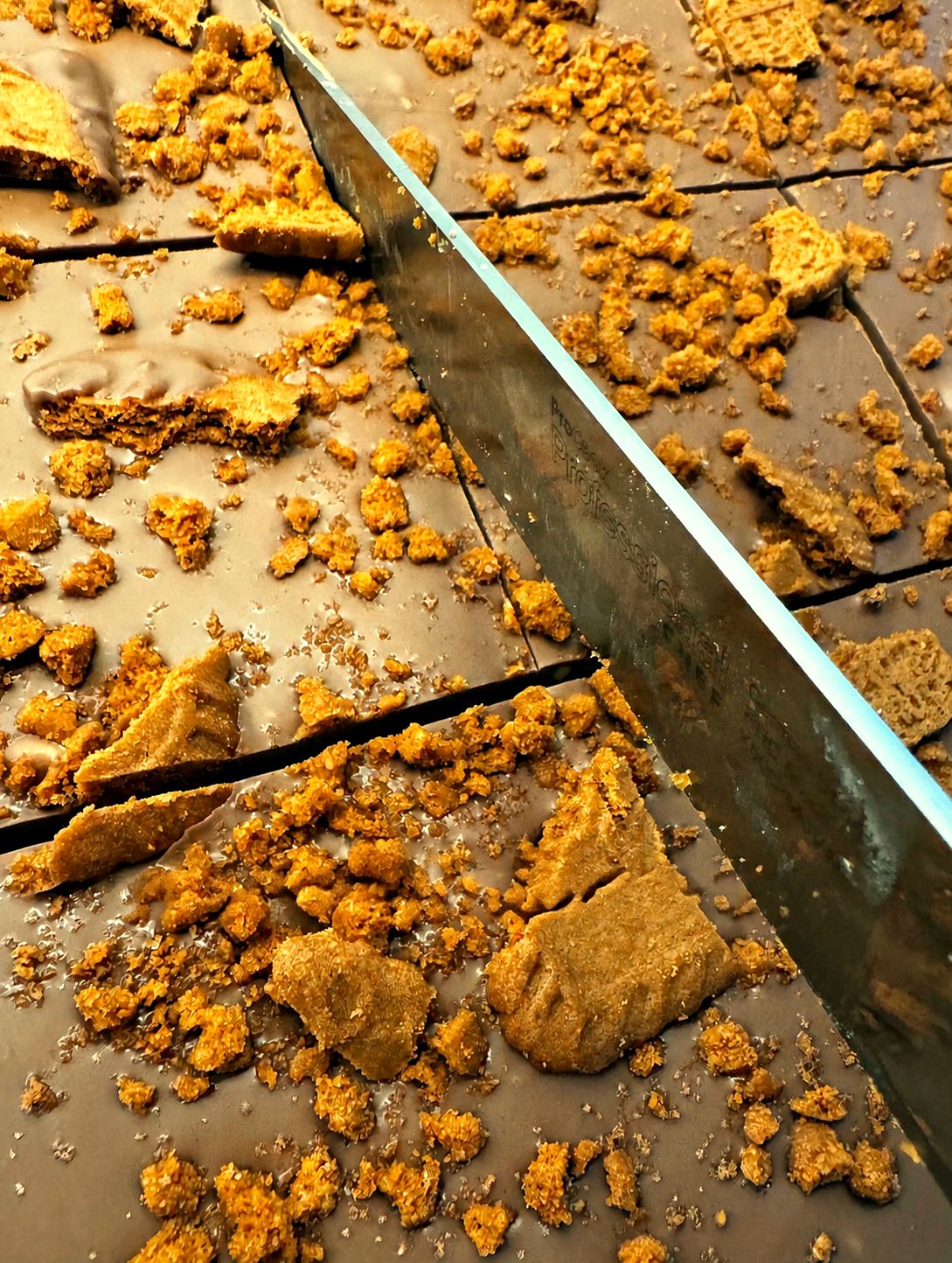 Tray of homemade Biscoff Millionaire traybake being sliced